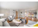 Bright living room featuring hardwood floors, comfortable seating, and an open layout for modern living at 1529 Ashcroft Dr, Longmont, CO 80501