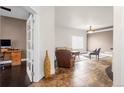 Inviting living room with tile flooring, comfortable seating, and ample natural light streaming through a window at 22134 Wintergreen Way, Parker, CO 80138