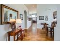 Open foyer with hardwood floors, decorative mirror, and furniture creates a welcoming entrance at 6642 S Routt St, Littleton, CO 80127
