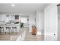 Open concept kitchen with a central island, barstool seating, and modern light fixtures at 8511 Cherry Ln, Westminster, CO 80031