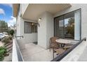 Private patio with small table and chairs, offering a relaxing outdoor space at 1830 Newland Ct # 106, Lakewood, CO 80214