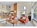 Relaxing living room boasts natural light, plush seating, fireplace and easy access to outdoor patio at 7877 S Ulster St, Centennial, CO 80112