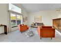 Spacious living room features vaulted ceilings, large windows, modern decor, and comfortable seating at 7877 S Ulster St, Centennial, CO 80112