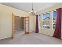 Inviting dining room featuring ample natural light, neutral carpet, and chandelier at 21690 Longs Peak Ln, Parker, CO 80138
