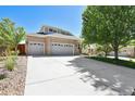 Attractive two-story home with a spacious driveway and lush green lawn at 20394 E Colgate Pl, Aurora, CO 80013