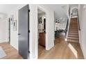 Bright hallway showcasing wood floors, stairway, and glimpses into other rooms at 3275 Lawrence St, Denver, CO 80205