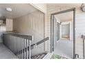 Hallway leading to a condo door with a neutral color scheme at 9222 E Arbor Cir # L, Englewood, CO 80111