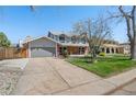 Beautiful exterior view of a two-story home with a well-manicured lawn and attached garage at 1430 S Lima St, Aurora, CO 80012