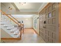 Bright foyer features tile flooring, staircase, and modern front door at 1430 S Lima St, Aurora, CO 80012