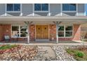 Inviting front porch with double doors, brick accents, and stylish outdoor seating at 1430 S Lima St, Aurora, CO 80012