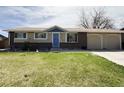 Attractive single-story home with a brick facade, attached garage and well-manicured lawn at 5690 W 79Th Ave, Arvada, CO 80003