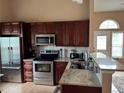 This modern kitchen boasts stainless steel appliances and stone countertops at 6887 S Dover Way, Littleton, CO 80128