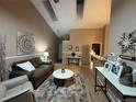 A cozy living room with vaulted ceilings, stylish decor, and hardwood floors at 6887 S Dover Way, Littleton, CO 80128