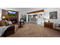 Inviting living room featuring a brick fireplace, exposed beam, and sliding glass door to the outside at 4899 S Dudley St # 3A, Littleton, CO 80123