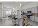 Modern kitchen featuring stainless steel appliances, granite countertops, and a large island with seating at 6956 S Titus St, Aurora, CO 80016