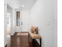 Bright entryway with hardwood floors, a bench, and a decorative rug creates a warm welcome at 19543 E 54Th Ave, Denver, CO 80249