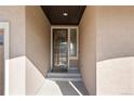 Inviting front entrance features a decorative storm door with glass panels and a covered porch at 19543 E 54Th Ave, Denver, CO 80249