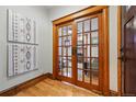 Elegant hallway featuring wood trim and glass paneled double doors leading to living space at 3928 Zuni St, Denver, CO 80211