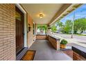 Inviting covered porch with brick accents, offering a relaxing outdoor space and neighborhood views at 3928 Zuni St, Denver, CO 80211