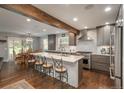 Spacious kitchen with island, breakfast bar, stainless appliances, and hardwood floors at 9325 Lark Sparrow Dr, Highlands Ranch, CO 80126
