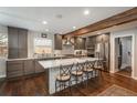 Stylish kitchen boasts a large island with seating, stainless steel appliances, and elegant gray cabinetry at 9325 Lark Sparrow Dr, Highlands Ranch, CO 80126
