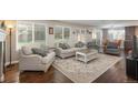 Bright living room with hardwood floors, neutral decor, and large windows overlooking backyard at 9325 Lark Sparrow Dr, Highlands Ranch, CO 80126