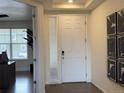 Bright entryway with white door, wood floors, and modern wall art at 2521 E 163Rd Pl, Thornton, CO 80602