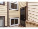 Exterior view of the home's front entrance, highlighting the door and window at 1159 S Otis Pl, Lakewood, CO 80232