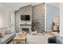 The cozy living room features a stone fireplace and modern furnishings at 1159 S Otis Pl, Lakewood, CO 80232