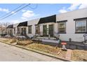 Charming townhomes showcasing unique front entryways with planters and black awnings along the sidewalk at 120 W Bayaud Ave, Denver, CO 80223