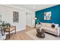 Cozy living room with a stylish sofa, a decorative rug, and an eye-catching blue accent wall at 120 W Bayaud Ave, Denver, CO 80223