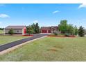 Exterior view featuring a house, large garage, circular driveway, and green landscaping at 3519 Zane Gray Loop, Parker, CO 80138