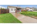 Attractive single-story home with a well-manicured lawn, featuring a front porch and a driveway leading to the property at 3100 W 94Th Ave, Westminster, CO 80031