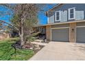 Charming two-story home with a two-car garage, landscaping, and inviting curb appeal on a sunny day at 7586 S Detroit St, Centennial, CO 80122