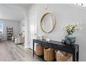 Stylish entryway featuring a modern console table with decorative baskets and a round mirror at 7315 Blue Water Dr, Castle Rock, CO 80108