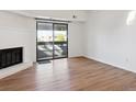 Bright living room featuring a fireplace and sliding glass door to a balcony at 14465 E 1St Dr # C7, Aurora, CO 80011