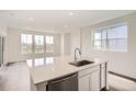 Kitchen with an island with stainless steel dishwasher and a large window at 577 Nightsky St, Erie, CO 80516