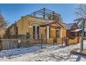 Yellow stucco home with a red tile roof and wrought-iron fence at 438 Inca St, Denver, CO 80204