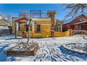 Spanish-style home with a rooftop deck and snow-covered yard at 438 Inca St, Denver, CO 80204