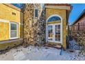 Home's side entrance with stonework and double French doors at 438 Inca St, Denver, CO 80204