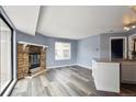 Living room boasts a stone fireplace, hardwood floors and a large window at 5250 S Huron Way # 1-204, Littleton, CO 80120