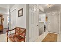 A clean foyer features a bench, tile floors, and access to various rooms at 6392 S Lafayette St, Centennial, CO 80121