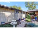 A beautiful walkway and garden at the front of a brick home. Also a fountain at 6392 S Lafayette St, Centennial, CO 80121