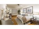 Inviting bedroom with modern decor, wood floors and comfortable seating at 2480 W Caithness Pl # 5, Denver, CO 80211