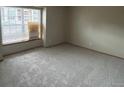 Cozy bedroom featuring neutral carpet, a large window with blinds, and ample natural light at 2690 E Otero Pl # 7, Centennial, CO 80122