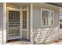 Close-up of the front door and window, showing the house's exterior finish at 5946 S Jellison St # F, Littleton, CO 80123