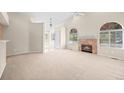 Bright living room with a fireplace and arched windows for natural light at 5946 S Jellison St # F, Littleton, CO 80123
