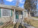 Inviting front porch with a charming wreath and cozy seating, creating a welcoming entrance at 1221 Ulster St, Denver, CO 80220