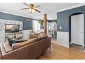 Open-concept living room featuring hardwood floors, neutral paint, and an abundance of natural light at 1221 Ulster St, Denver, CO 80220