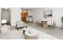 Open-concept living room and kitchen, featuring neutral tones and modern decor at 9385 E Center Ave # 1B, Denver, CO 80247